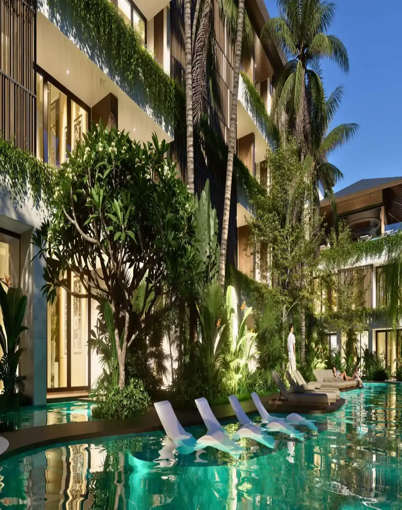 Pool deck with lounge chairs and lush planting